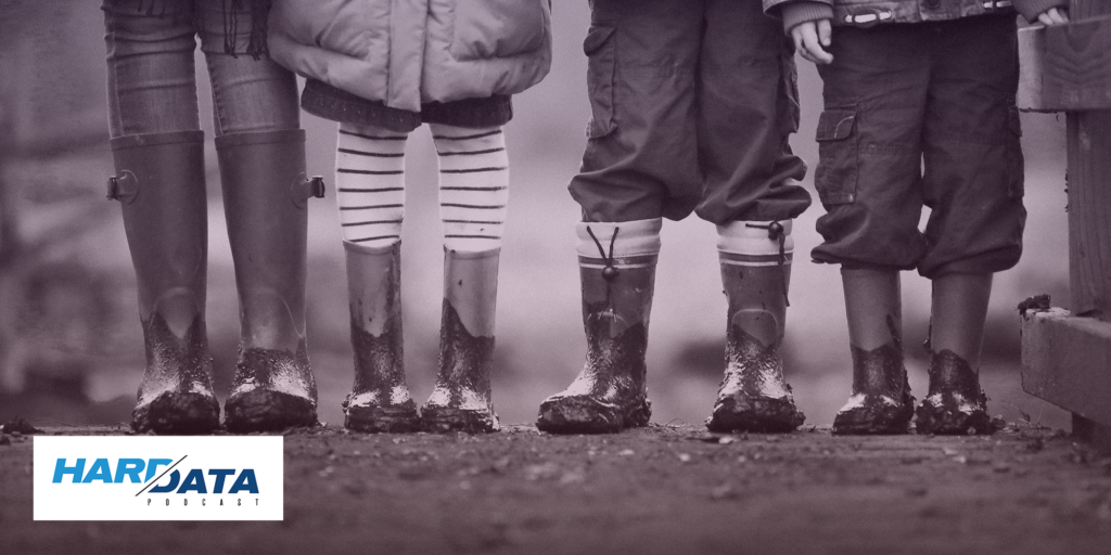 Four kids in rainboots standing in a line on a muddy path; Hard Data Podcast logo
